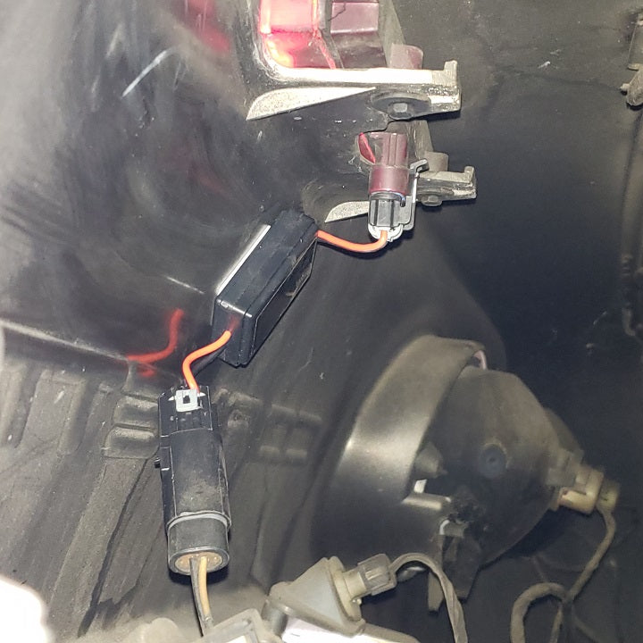 Warning Star third brake light pulse module installed on a Chevrolet Corvette C5, showing the plug-and-play wiring harness and sequential safety blinker